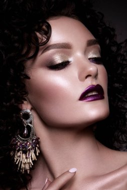 Brunette girl with long and shiny curly hair . Beautiful model woman with wavy hairstyle . High quality photo