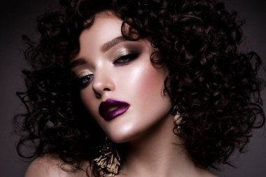 Brunette girl with long and shiny curly hair . Beautiful model woman with wavy hairstyle . High quality photo