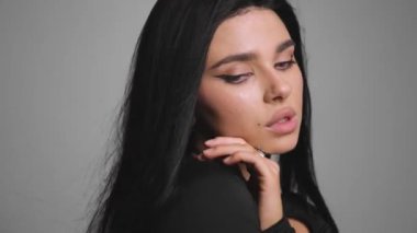 Profilde uzun ve parlak saçlı güzel bir kadın var. Siyah saçlı güzel bir kız. Yüksek kaliteli video