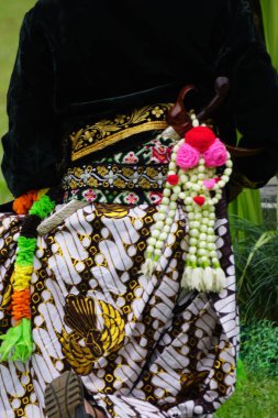 Keris on the back of Javanese. Keris is one of the Indonesian traditional weapons. People who make keris are called empu