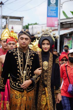 Indonesian with traditional wedding costumes at a celebration of grebeg pancasila. Grebeg Pancasila is held to celebrate Pancasila day