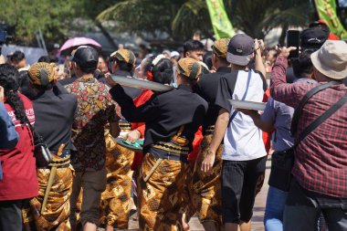 Javanese thanksgiving (Indonesian also call it Larung Semboyo, labuh laut, larung sesaji, sedekah laut). This thanksgiving held in sine beach