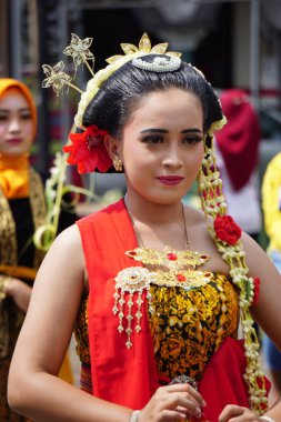 Indonesian with a traditional javanese cloth on 1800 chocolate ketupat cultural carnival festival (Kirab Budaya 1800 ketupat coklat)