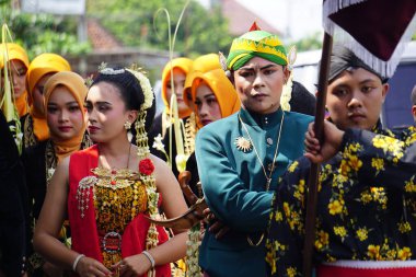 Indonesian with a traditional javanese cloth on 1800 chocolate ketupat cultural carnival festival (Kirab Budaya 1800 ketupat coklat)