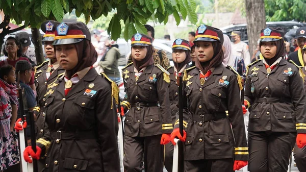 Indonesian senior high school students with uniforms in marching.