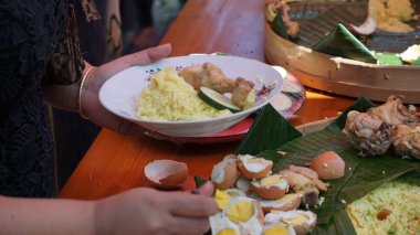 Şefin servis ettiği Nasi Tumpeng (koni pilavı), urap-urap (Endonezya salatası), kızarmış tavuk ve erişte ile servis edilir. Nasi Tumpeng genellikle doğum günü partilerinde ya da Şükran Günü 'nde servis edilir.