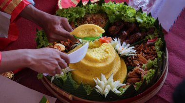 Şefin servis ettiği Nasi Tumpeng (koni pilavı), urap-urap (Endonezya salatası), kızarmış tavuk ve erişte ile servis edilir. Nasi Tumpeng genellikle doğum günü partilerinde ya da Şükran Günü 'nde servis edilir.