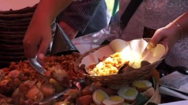 Şefin servis ettiği Nasi Tumpeng (koni pilavı), urap-urap (Endonezya salatası), kızarmış tavuk ve erişte ile servis edilir. Nasi Tumpeng genellikle doğum günü partilerinde ya da Şükran Günü 'nde servis edilir.
