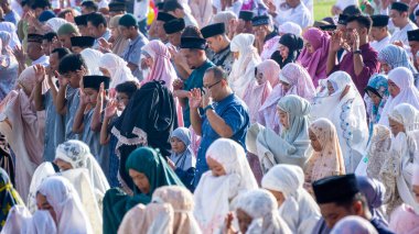 Muslims pray Eid prayers in the morning in the Blitar city square clipart
