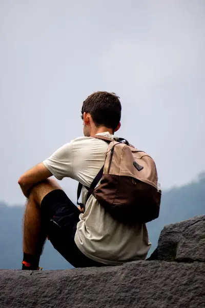 stock image Foreign tourists on a large rock with a view of Mount Kelud