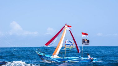 The ceremony of pethik laut in tambakrejo beach. This ceremony is a celebration for fishermen who drown goats' heads in the sea clipart