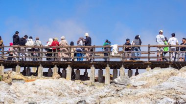 People vacation on Sikidang Crater (kawah sikidang), one of the famous tourist destinations in Wonosobo. clipart