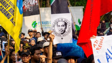 Students demonstrate by carrying signs that mean they reject dynasty politics and changes to the election law. clipart