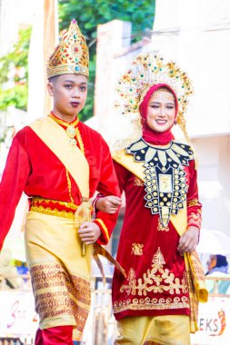 Traditional clothes from North Sulawesi on the 3rd BEN Carnival. clipart