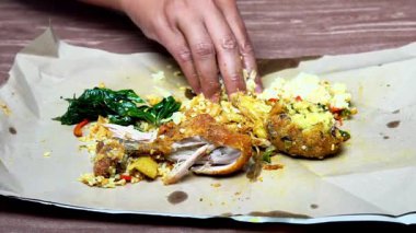 Nasi Padang 'i elle yemek. Nasi padang, Endonezya 'nın batı Sumatera bölgesinden bir yiyecek.