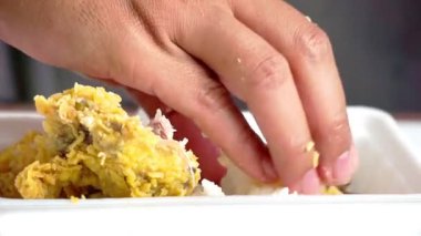 Ayam geprek yemek (Endonezya baharatlı kızarmış tavuk) pilavlı ve elleri köpüklü
