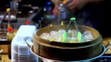 Bambu buharlı buharlı dondurmanın manzarası. Pazarda müşterilerine hizmet eden satıcı..