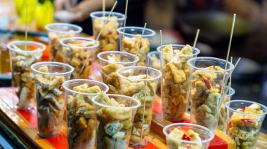 Plastik bardakta Tahu Gejrot. Tahu Gejrot, Endonezya 'nın baharatlı tatlı soslu soya peyniri.