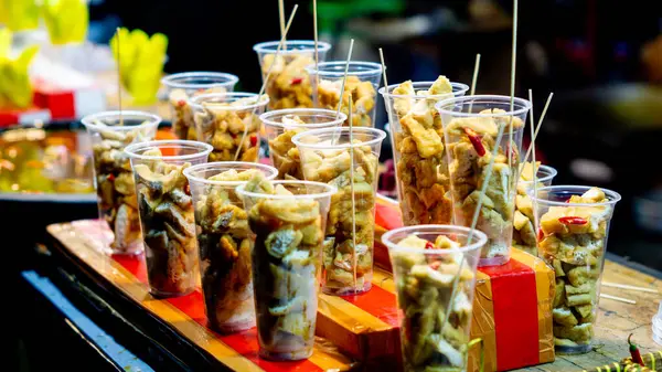 Plastik bardakta Tahu Gejrot. Tahu Gejrot, Endonezya 'nın baharatlı tatlı soslu soya peyniri.