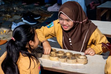 Güneydoğu Asya mankalası (congkak, congklak, tjongklak, congka, chonca, chongca, dakon, sungka). Geleneksel bir oyun.