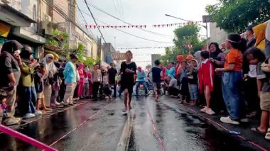 İnsanlar Endonezya 'nın bağımsızlık gününü kutlamak için bir su transferi yarışına katılıyor..