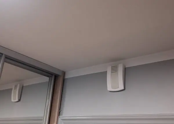 Rectangular apartment doorbell mounted outside the apartment, next to the entrance door. Classic design still commonly seen in older buildings and modern multi-story residences.