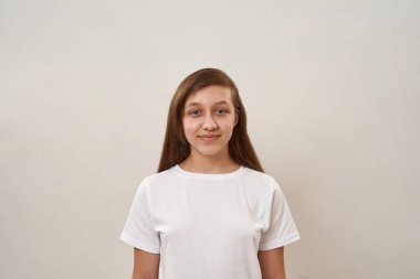 Cropped image of smiling caucasian teenage girl looking at camera. Female child of zoomer generation. Concept of modern youngster lifestyle. Isolated on white background. Studio shoot. Copy space