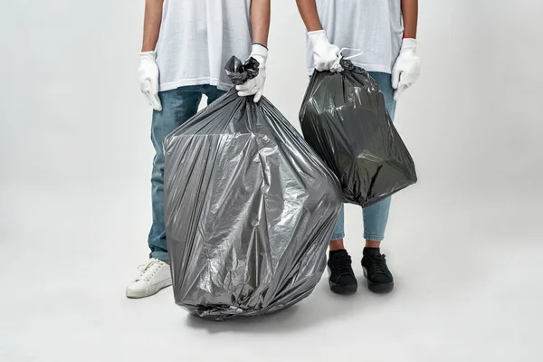 种植多种族夫妇志愿者拿着完整的垃圾袋 志愿服务 生态安全与保护 废物处理和回收利用 被白色背景隔离 工作室拍摄 复制空间 — 图库照片