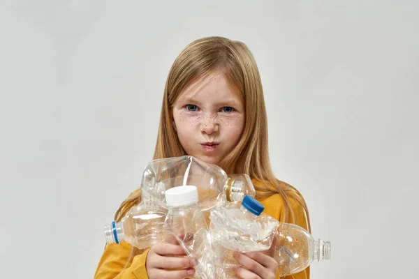 Dissatisfied Caucasian Little Girl Holding Used Plastic Bottles Looking Camera — Stock Photo, Image