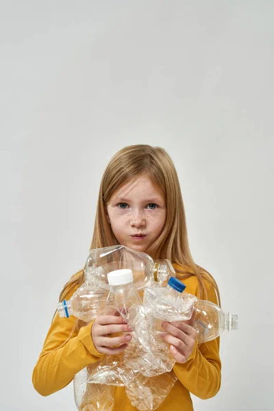 Displeased Caucasian Little Girl Hold Used Plastic Bottles Look Camera — Stock Photo, Image