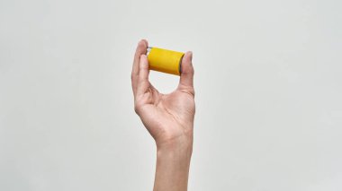Cropped male hand holding battery. Energy saving. Ecology safety and protection. Waste disposal and recycling. Environmental sustainability. Isolated on white background. Studio shoot. Copy space