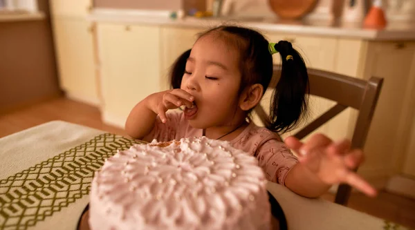 Cute Little Asian Girl Closed Eyes Eating Sweet Cake Table — 图库照片