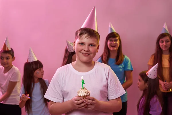 Smiling Caucasian Boy Holding Birthday Cupcake Burning Candle Background Celebrating Imágenes de stock libres de derechos