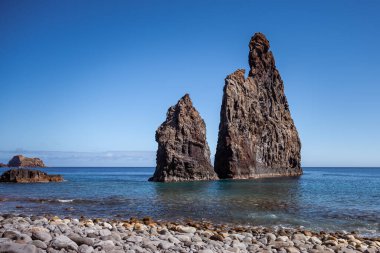 Tall lava rocks in ocean, islet towers in Ribeira da Janela, Madeira, Portugal
