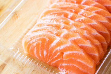 Sliced fresh raw salmon sashimi in a Japanese restaurant. Fresh salmon sashimi and Japanese food concept.	
