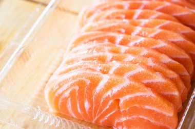 Sliced fresh raw salmon sashimi in a Japanese restaurant. Fresh salmon sashimi and Japanese food concept.	