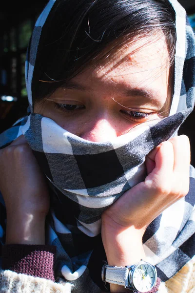 Asian local woman covering up a black and white zebra loincloth covers the face.