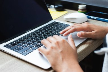 Modern bir çalışma alanında dizüstü bilgisayarda yazı yazan eller. Uzak çalışma, çevrimiçi öğrenme, dijital iş veya serbest verimlilik kavramı.