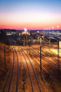 Akşam manzaralı bir tren istasyonunda. Polonya Kielce Herby İstasyonu 'ndaki tren rayları..