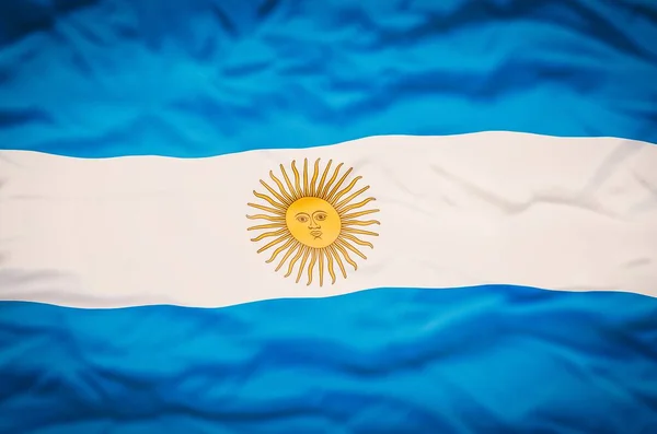 Argentina flag on a fabric wavy background. Wavy flag of Argentina fills the frame.