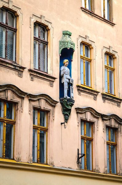Torun, Poland - February 21, 2105: Sculpture of knight in Torun, Poland. Architectural detail of gothic tenement house in old town Torun, listed by UNESCO organisation.