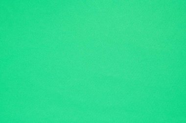 Yeşil kumaş dokusu. Yumuşak pamuk kumaş yakın plan, arka plan olarak kullanılabilir.