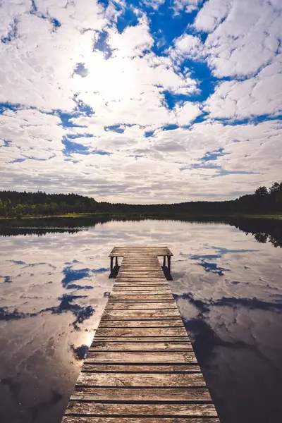 stock image Beautiful summer afternoon landscape by the lake. Charming wooden pier over a small lake in Michala Gora, Poland.