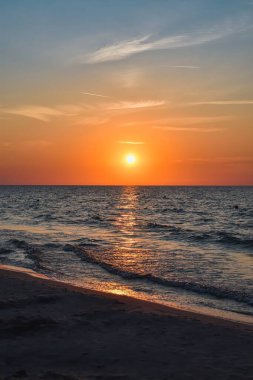 Denizin üzerinde güzel renkli gün batımı. Polonya Baltık Denizi 'nde akşam kumsalda.