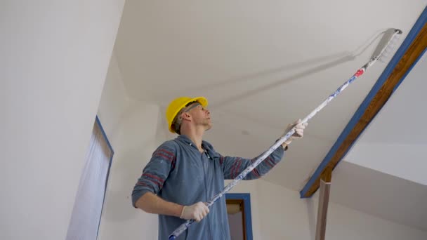 Adult Man Paints Wall Roller Makes Repairs Room Attic Floor — Stock video