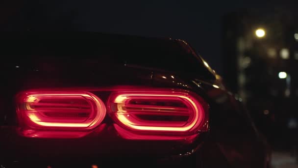 Black Sports Car Tail Light Glowing Dark Night City Flashing — Stock Video