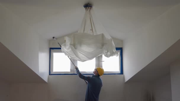 Adult Man Paints Wall Roller Makes Repairs Room Attic Floor — стоковое видео