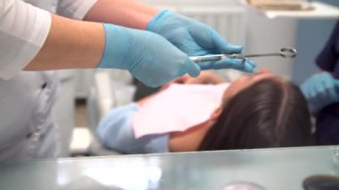 Dentist at work with an assistant performs anesthesia procedure