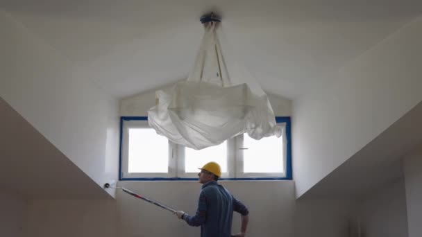 Adult Man Paints Wall Roller Makes Repairs Room Attic Floor — Stock Video