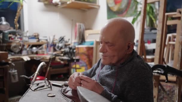 Senior Elderly Master Jeweler Wheelchair Works Workshop Anvil — Stockvideo